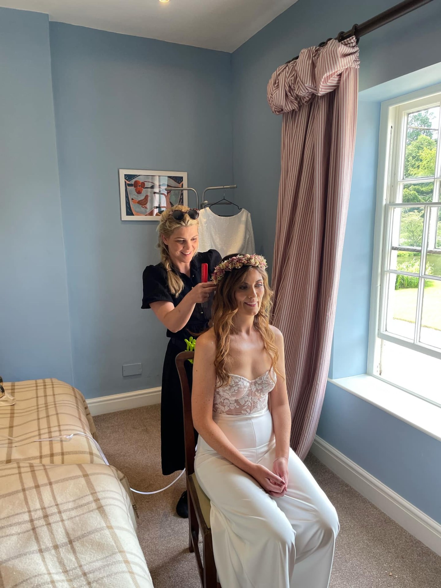 Becky styling a bride's hair on the wedding morning at her venue